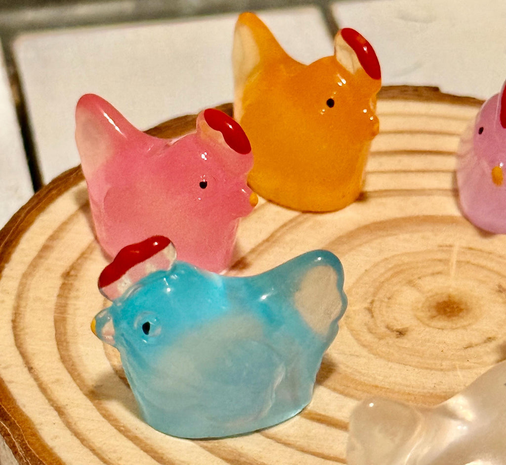 Miniature colorful hen figurines
