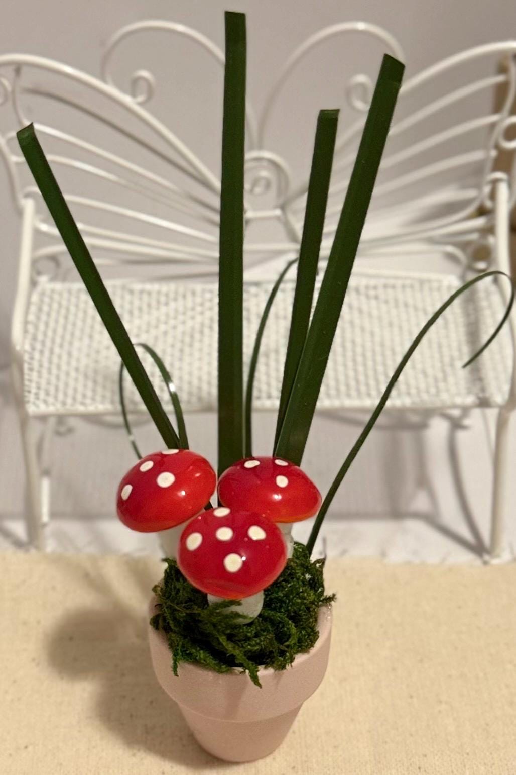 Miniature mushrooms in clay pot