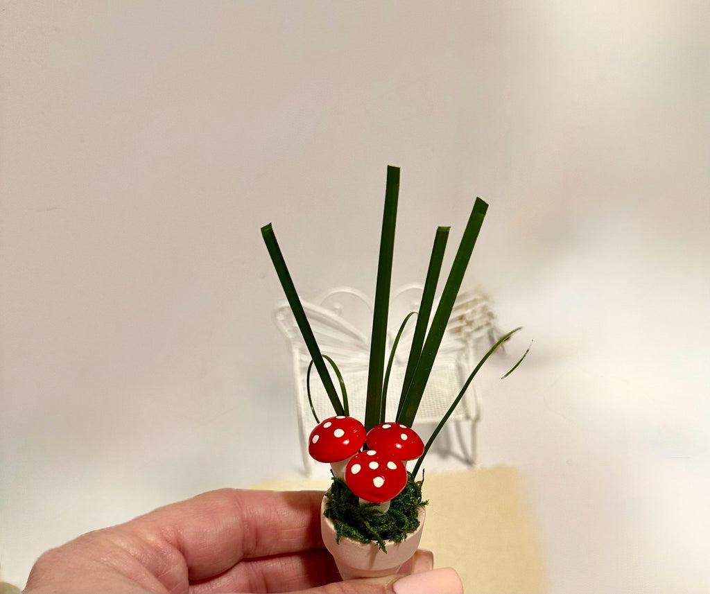 Miniature mushrooms in clay pot
