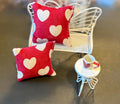 Miniature heart shaped dollhouse throw pillow.
