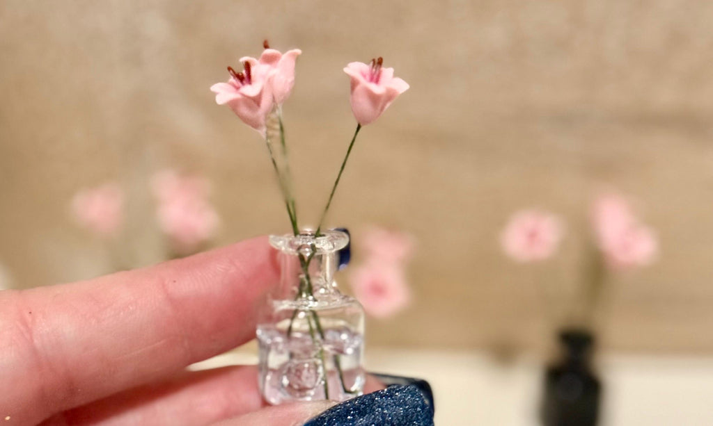 Miniature lilies in vintage glass jar