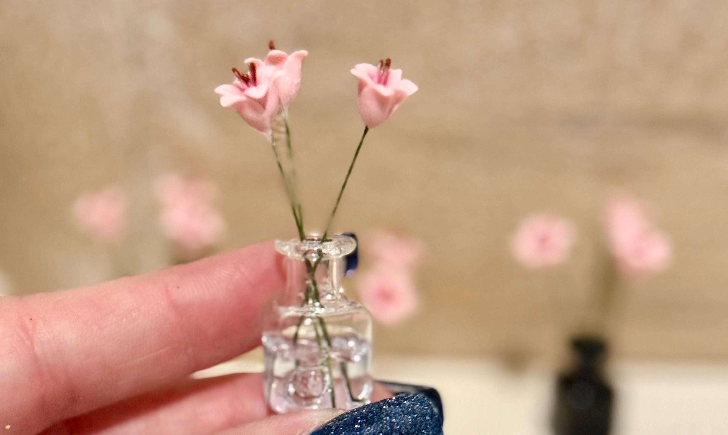 Miniature lilies in vintage glass jar