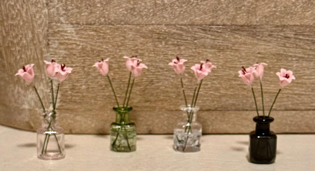 Miniature lilies in vintage glass jar