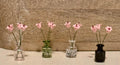 Miniature lilies in vintage glass jar