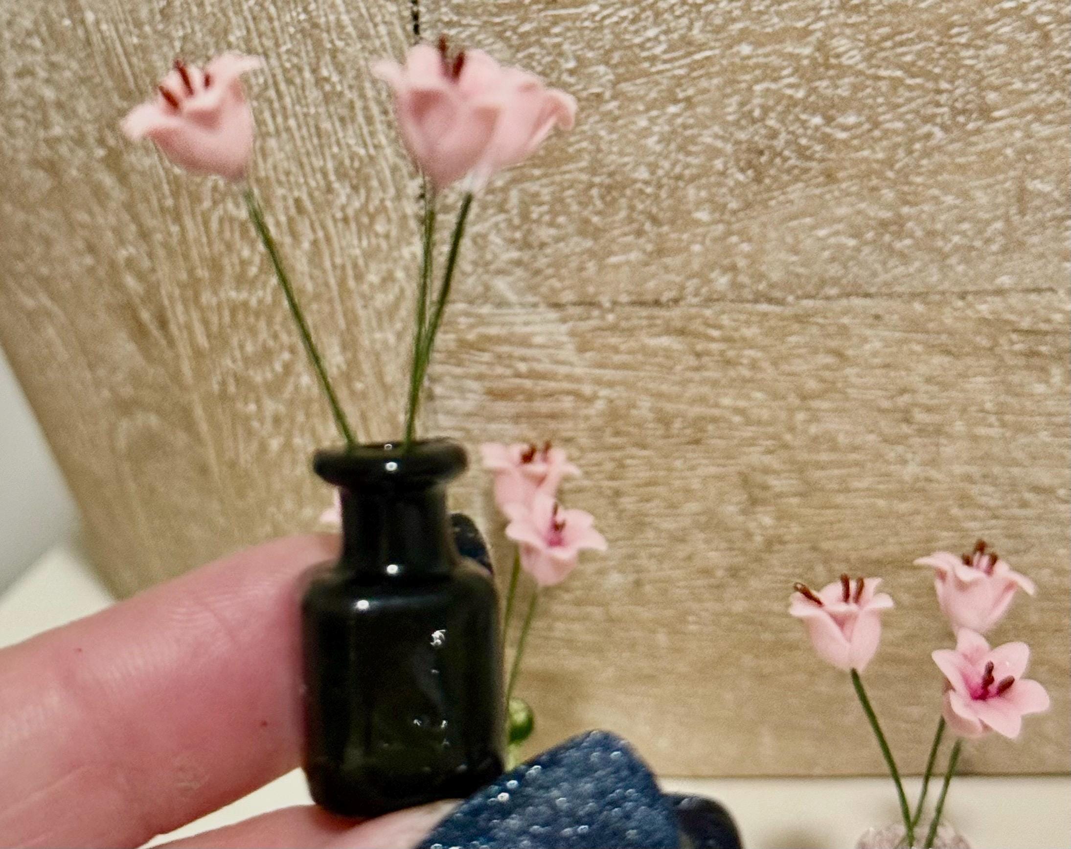Miniature lilies in vintage glass jar