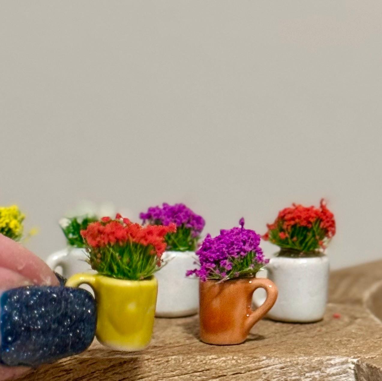 Miniature ceramic coffee mugs with plants