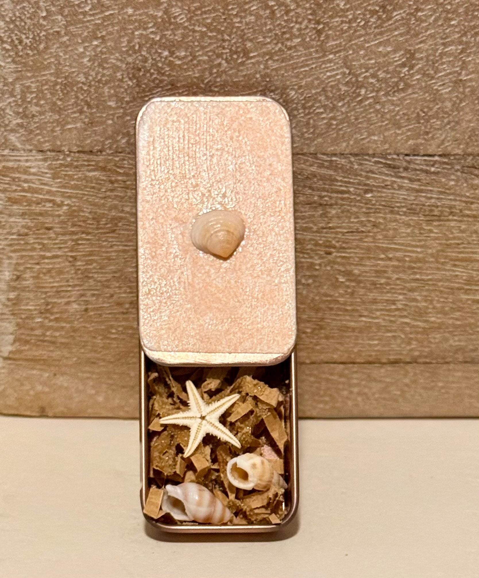 Metal treasure mini sliding box filled with mini shells and a starfish