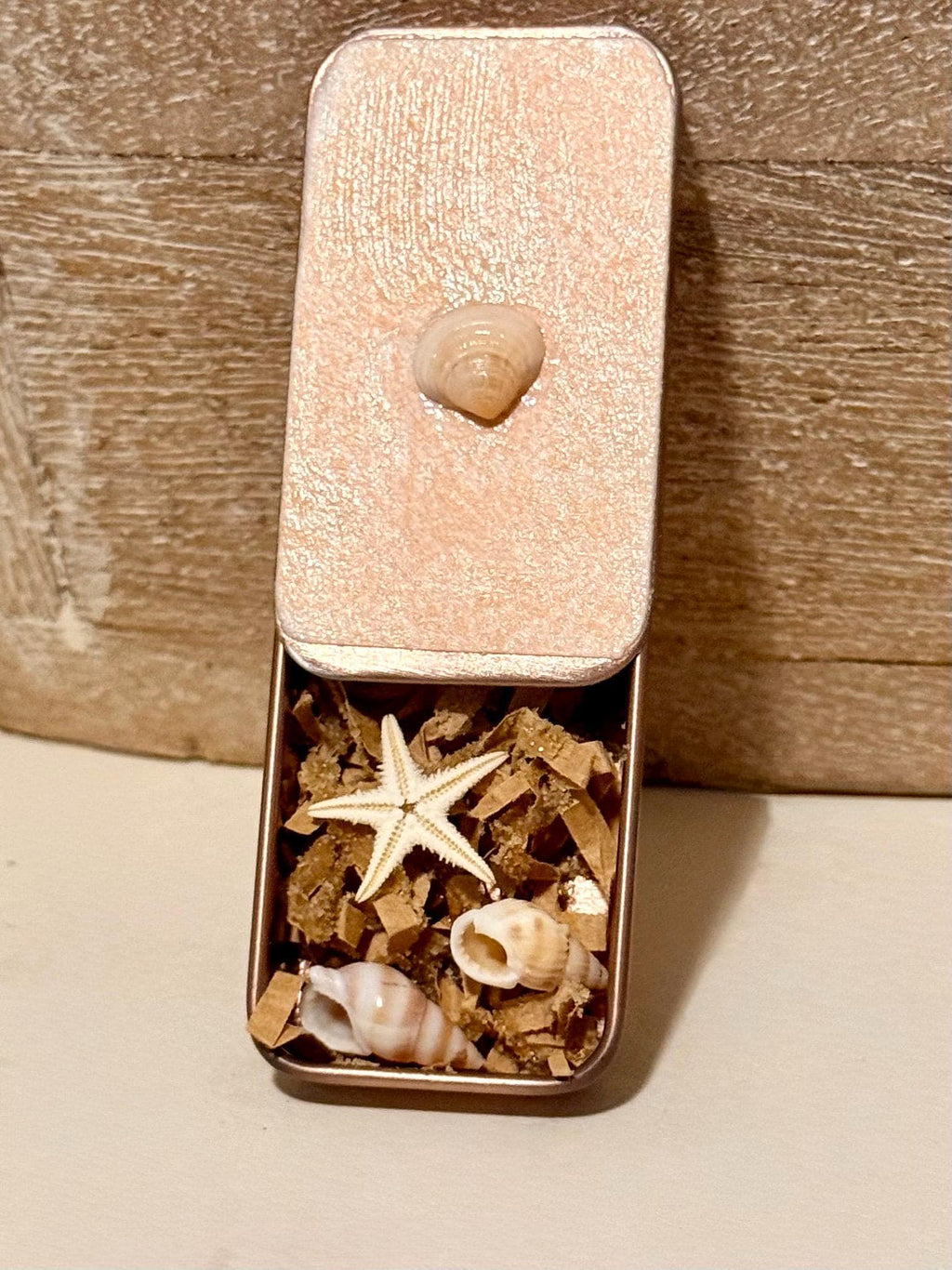 Metal treasure mini sliding box filled with mini shells and a starfish