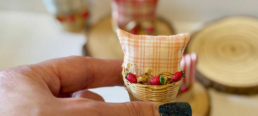 Miniature basket filled with a mini throw pillow and strawberries