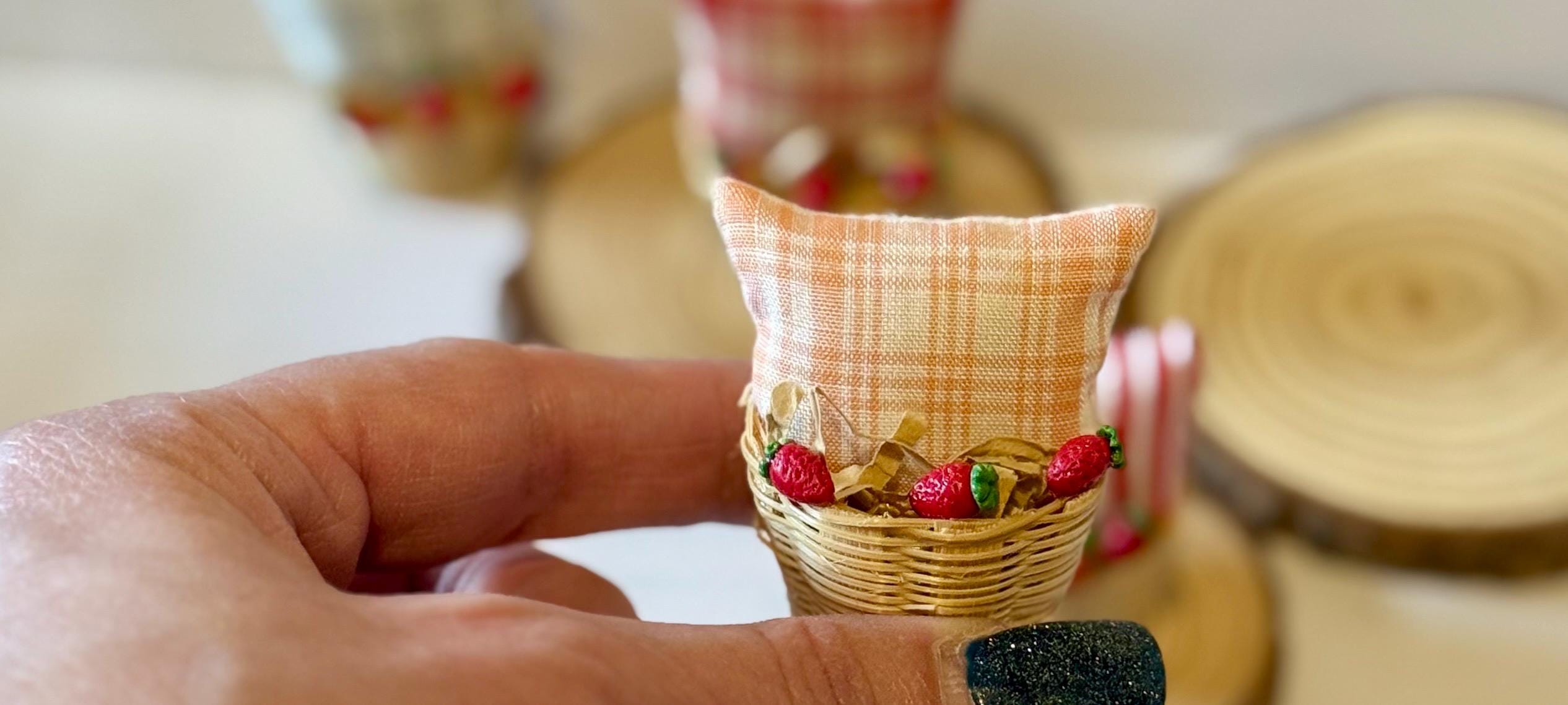 Miniature basket filled with a mini throw pillow and strawberries
