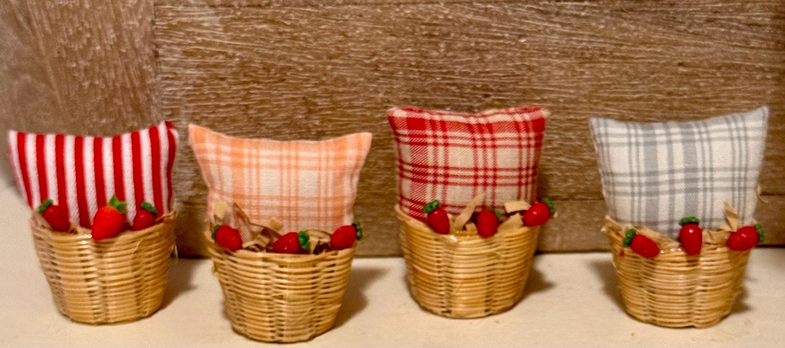 Miniature basket filled with a mini throw pillow and strawberries