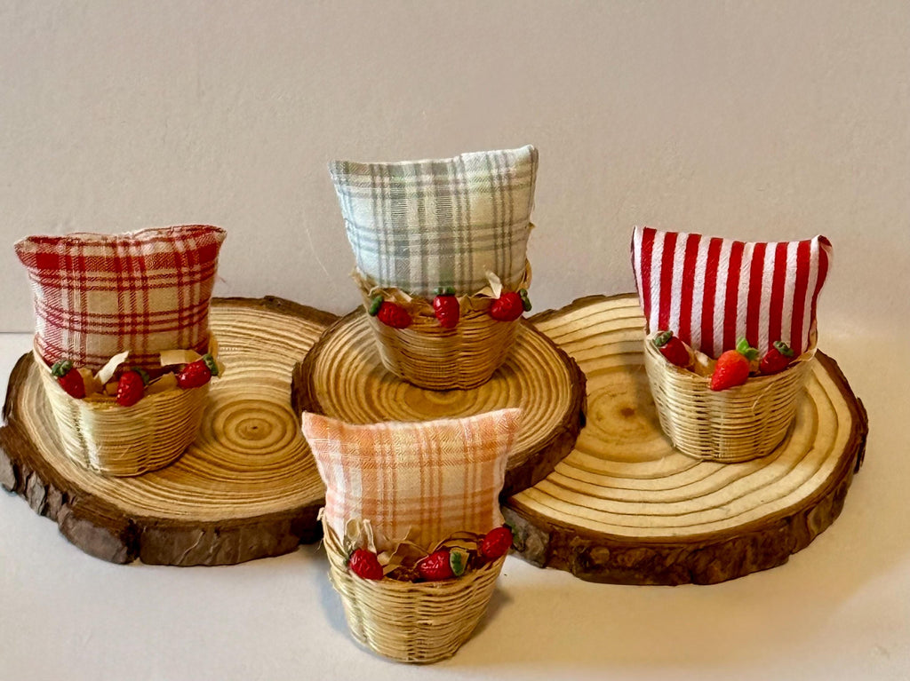 Miniature basket filled with a mini throw pillow and strawberries