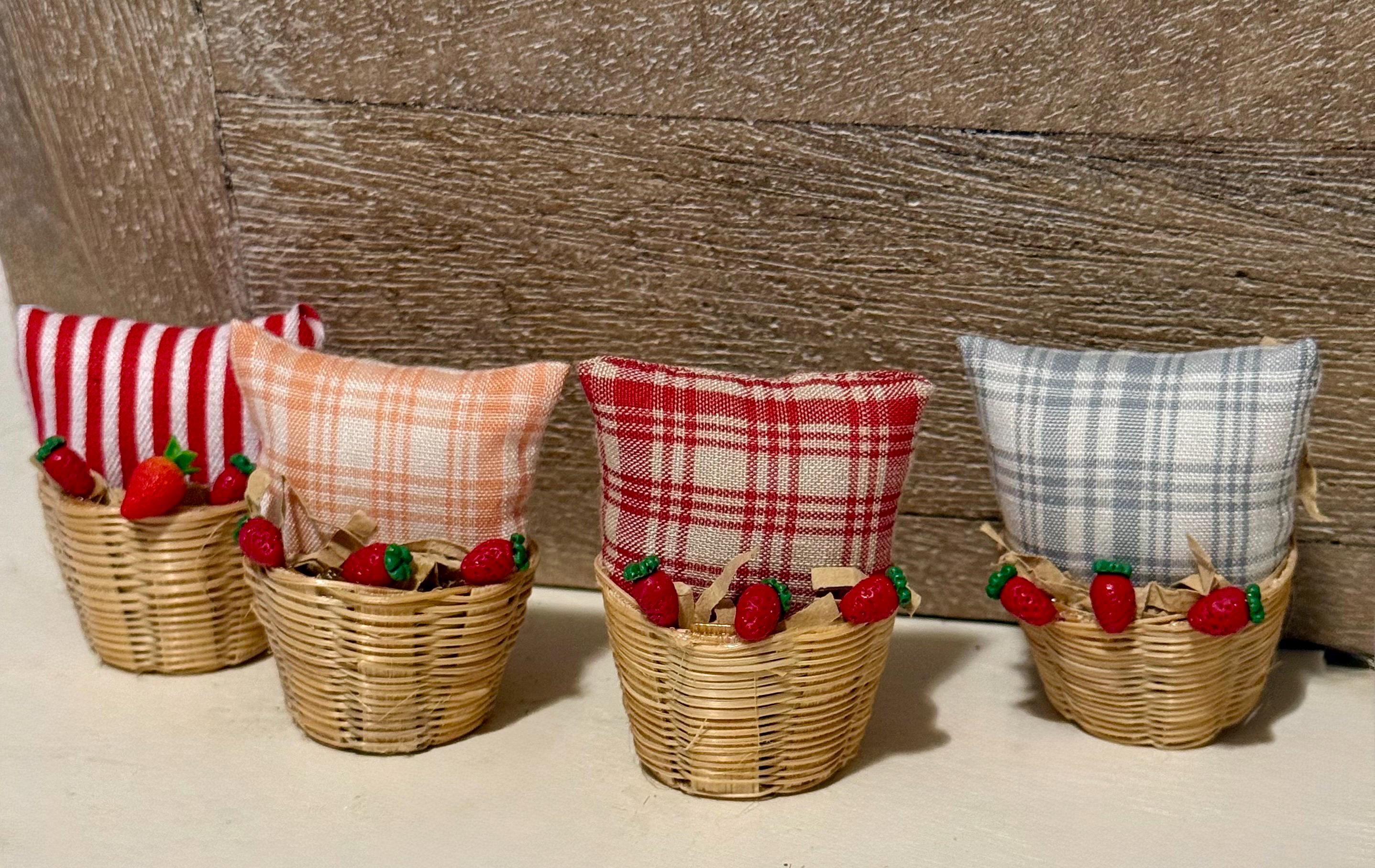 Miniature basket filled with a mini throw pillow and strawberries