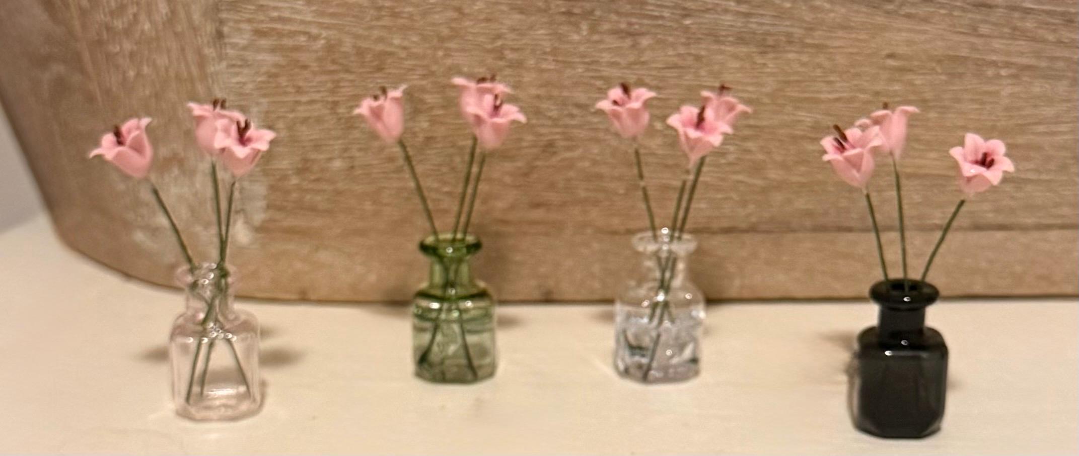Miniature lilies in vintage glass jar