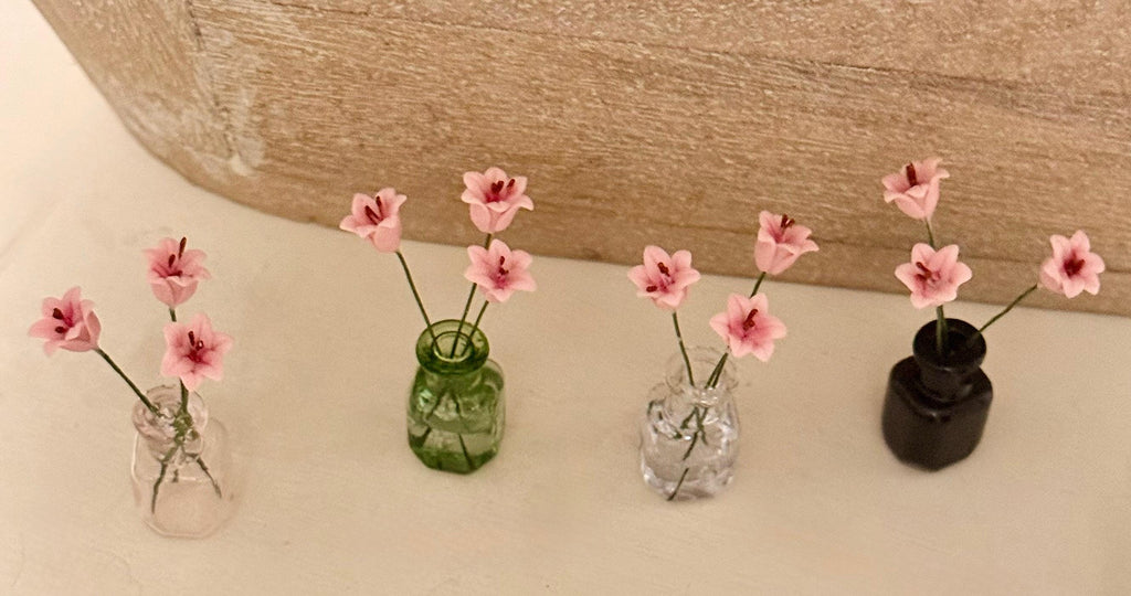 Miniature lilies in vintage glass jar