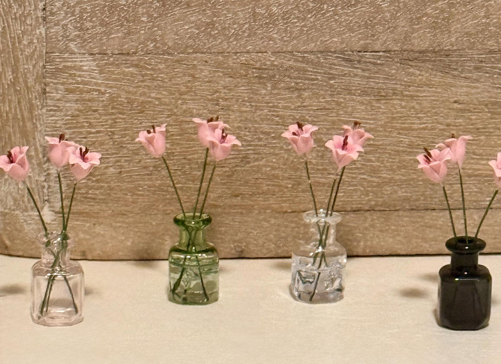 Miniature lilies in vintage glass jar