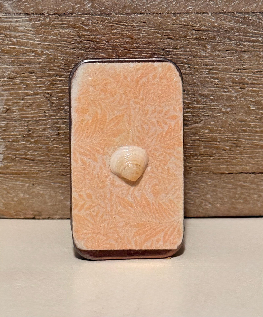 Metal treasure mini sliding box filled with mini shells and a starfish