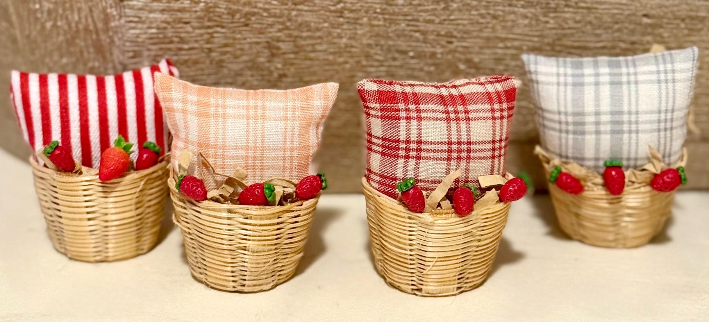 Miniature basket filled with a mini throw pillow and strawberries