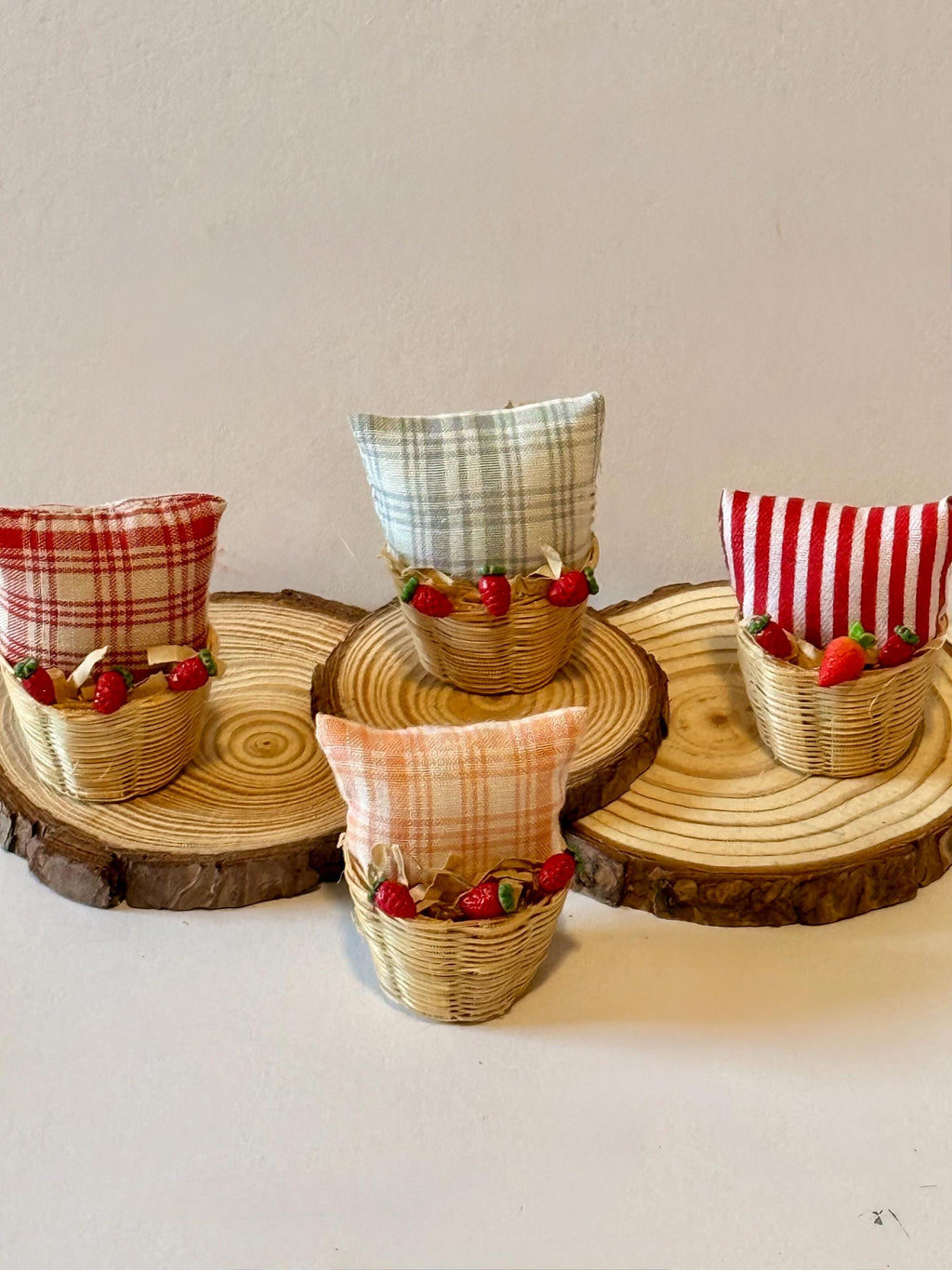 Miniature basket filled with a mini throw pillow and strawberries