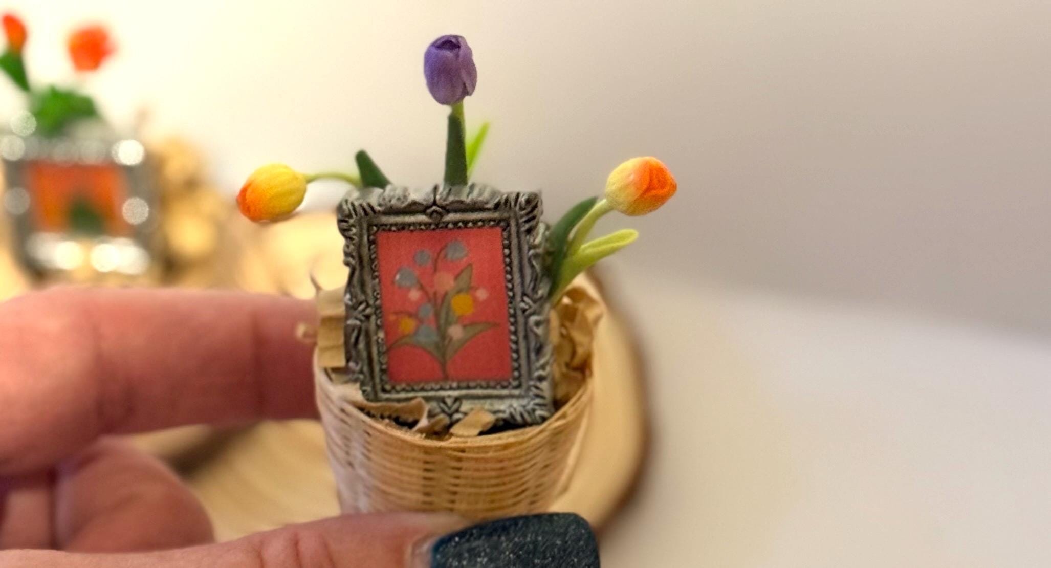 Miniature flowers and floral art frame in basket